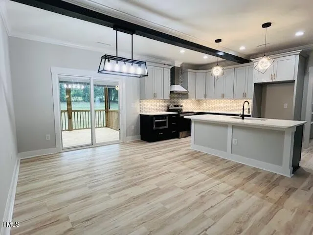 a large kitchen with stainless steel appliances granite countertop a stove top oven a sink dishwasher a dining table and chairs with wooden floor