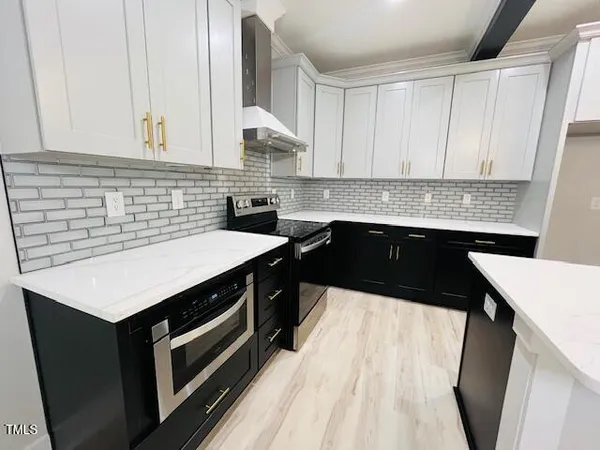 a kitchen that has a sink and a stove in it