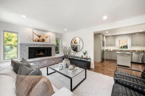 a living room with furniture and a fireplace