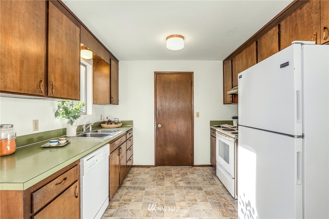 22229 17th Place West Bothell, WA 98021 - Photo 13 of 25 a kitchen with a refrigerator a sink and a stove