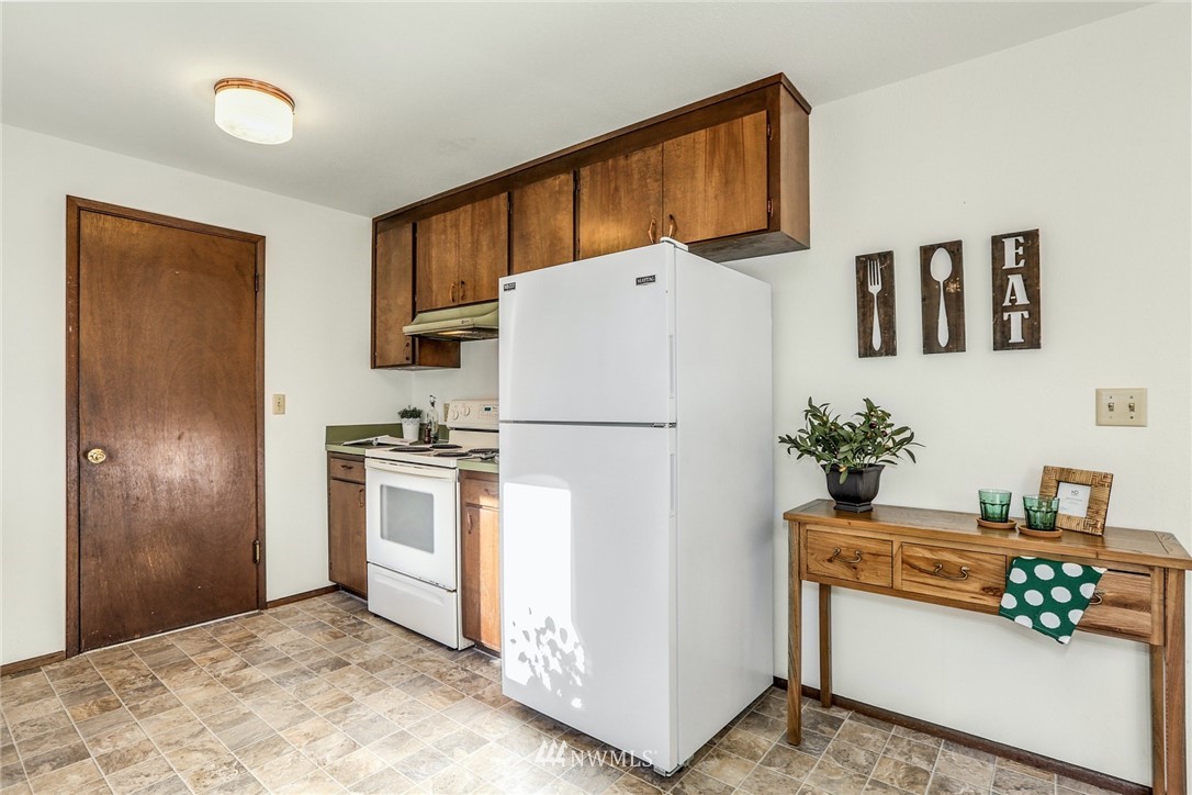 22229 17th Place West Bothell, WA 98021 - Photo 15 of 25 a white refrigerator freezer sitting in a kitchen