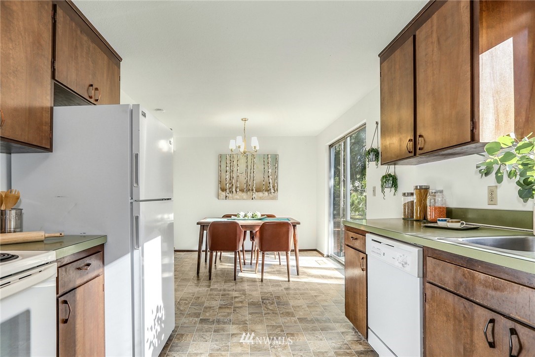 22229 17th Place West Bothell, WA 98021 - Photo 16 of 25 a kitchen with stainless steel appliances granite countertop a refrigerator and a stove top oven