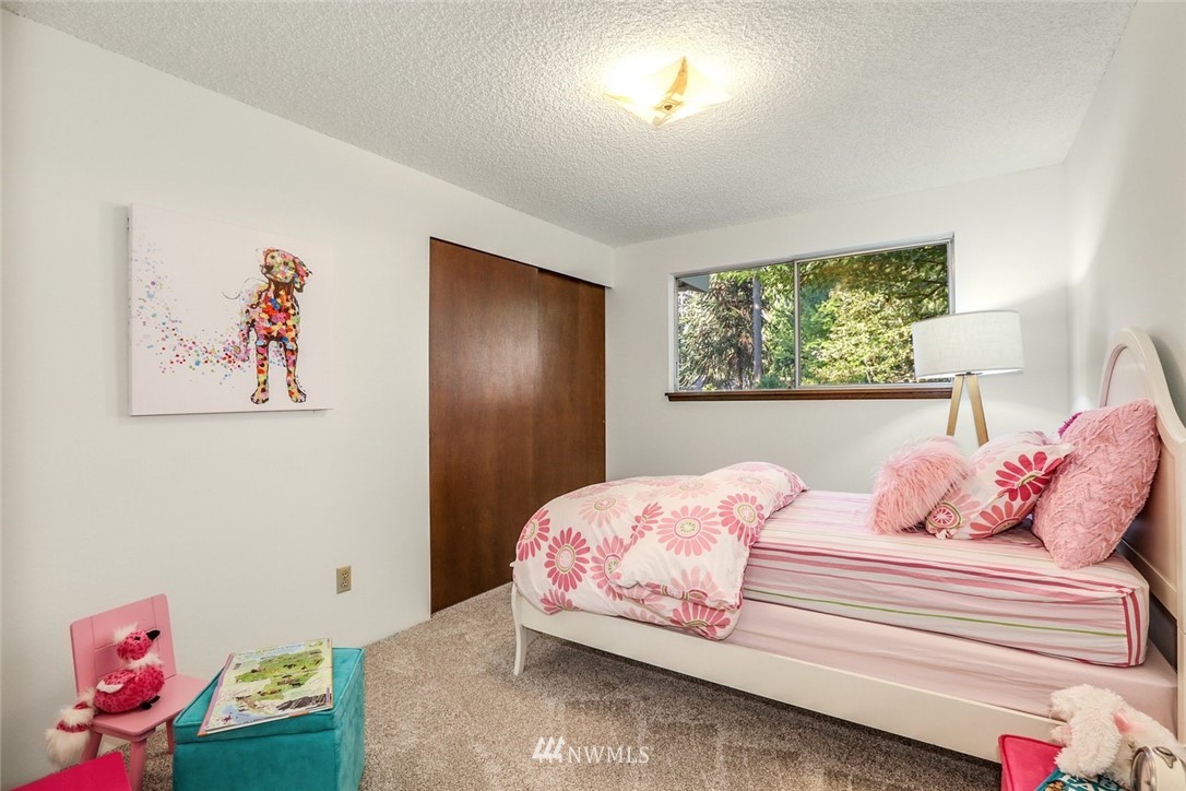 22229 17th Place West Bothell, WA 98021 - Photo 18 of 25 a bedroom with a bed and a painting on the wall