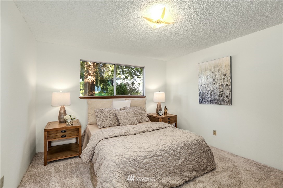 22229 17th Place West Bothell, WA 98021 - Photo 21 of 25 a bedroom with a bed and a painting on the wall