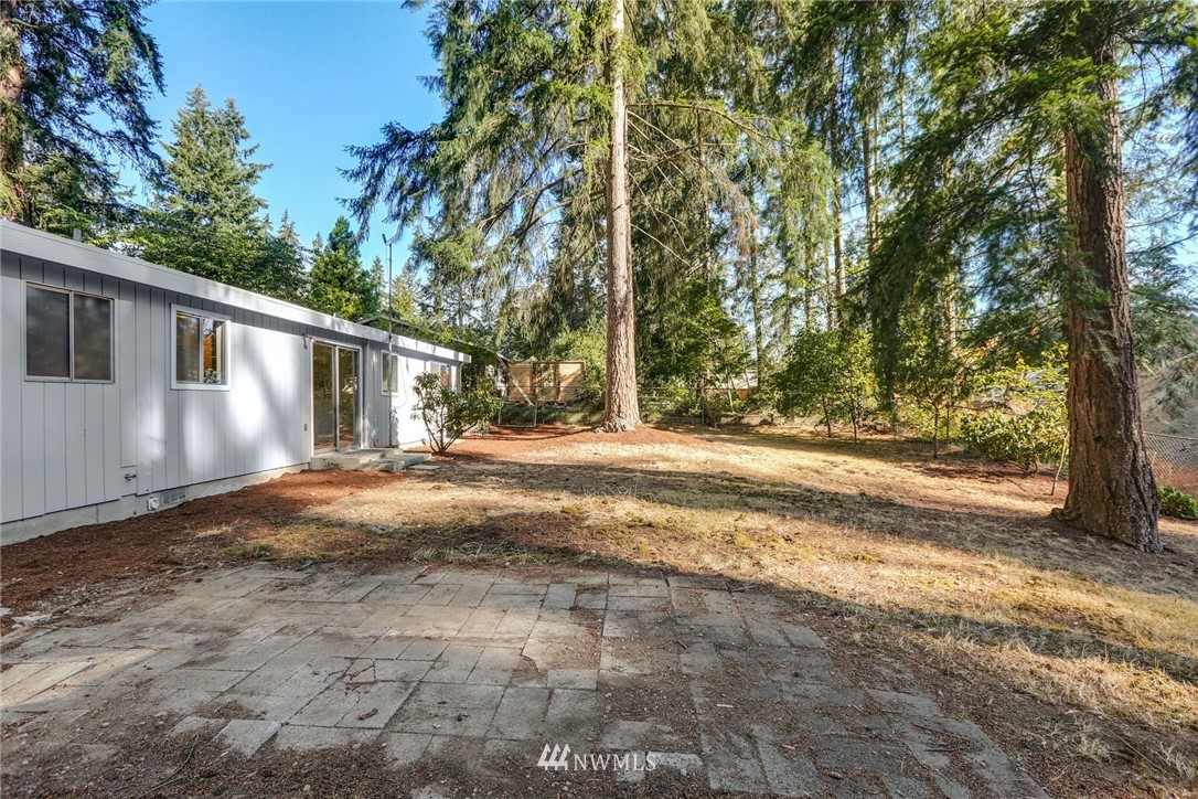 22229 17th Place West Bothell, WA 98021 - Photo 24 of 25 a view of a house with backyard and trees