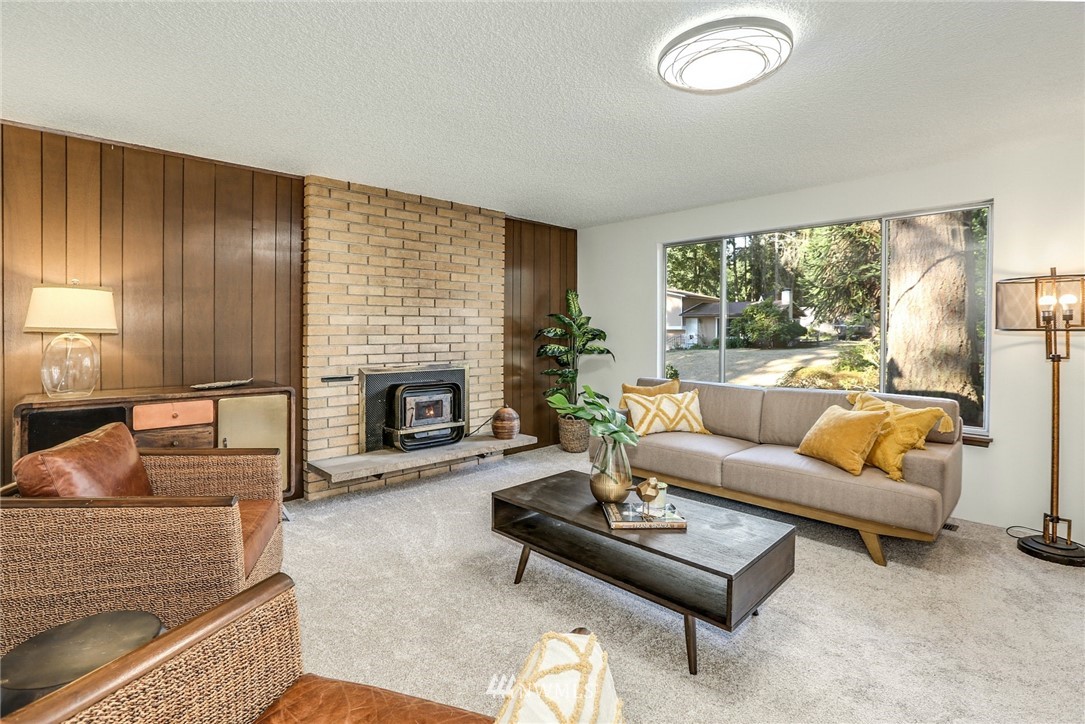 22229 17th Place West Bothell, WA 98021 - Photo 10 of 25 a living room with furniture a fireplace and a large window
