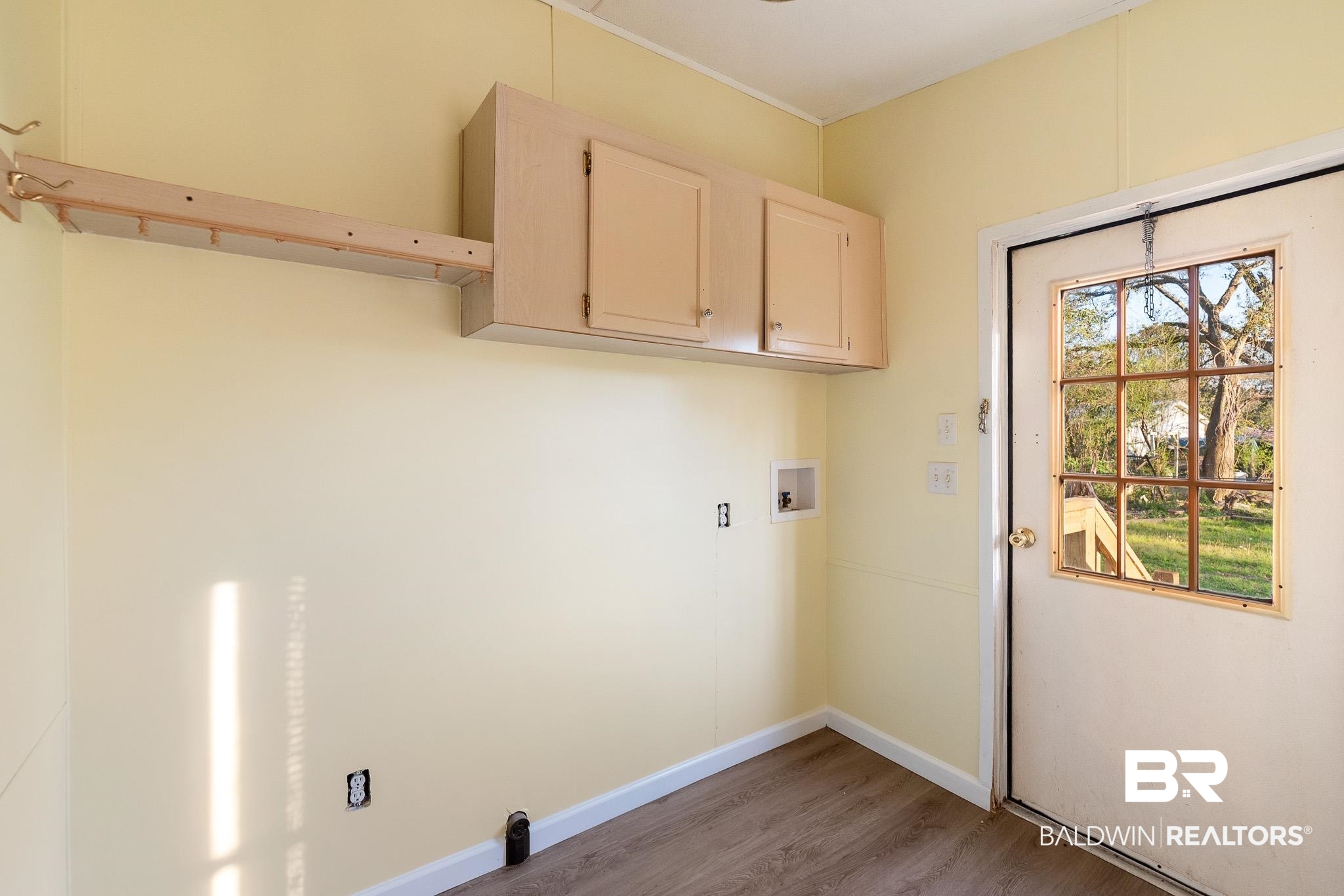 7695 Bermuda Drive Semmes, AL 36575 - Photo 27 of 27 Washroom featuring light wood finished floors, cabinet space, baseboards, and washer hookup