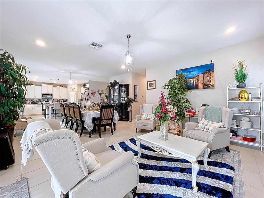 472 6th Avenue Northwest Ruskin, FL 33570 - Photo 29 of 96 a living room with furniture and a chandelier