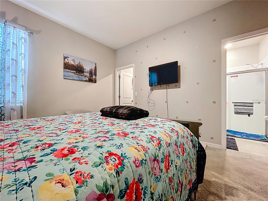 472 6th Avenue Northwest Ruskin, FL 33570 - Photo 32 of 96 a bedroom with a bed and a flat screen tv