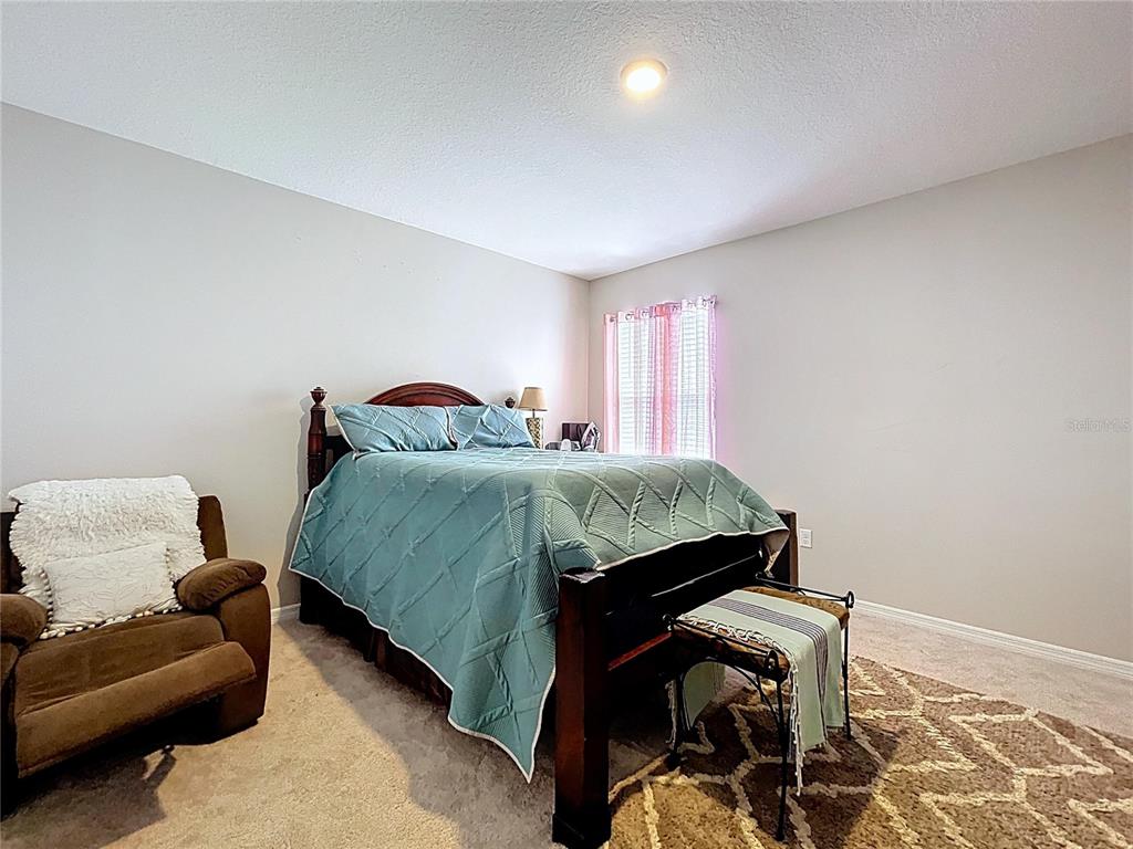 472 6th Avenue Northwest Ruskin, FL 33570 - Photo 58 of 96 a bedroom with a bed and a couch