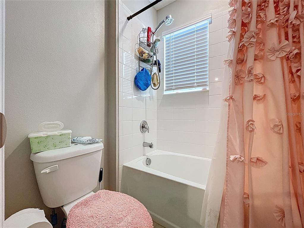 472 6th Avenue Northwest Ruskin, FL 33570 - Photo 69 of 96 a bathroom with a sink a toilet a shower curtain and a bath tub