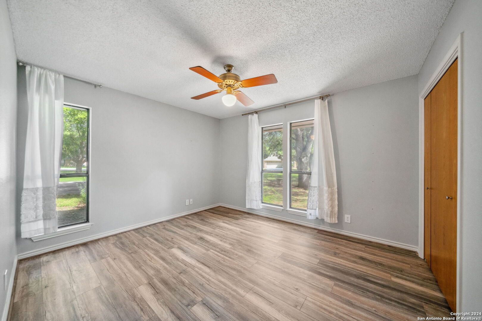 116 Bobwhite Trail Seguin, TX 78155 - Photo 15 of 23 a view of an empty room with window and wooden floor
