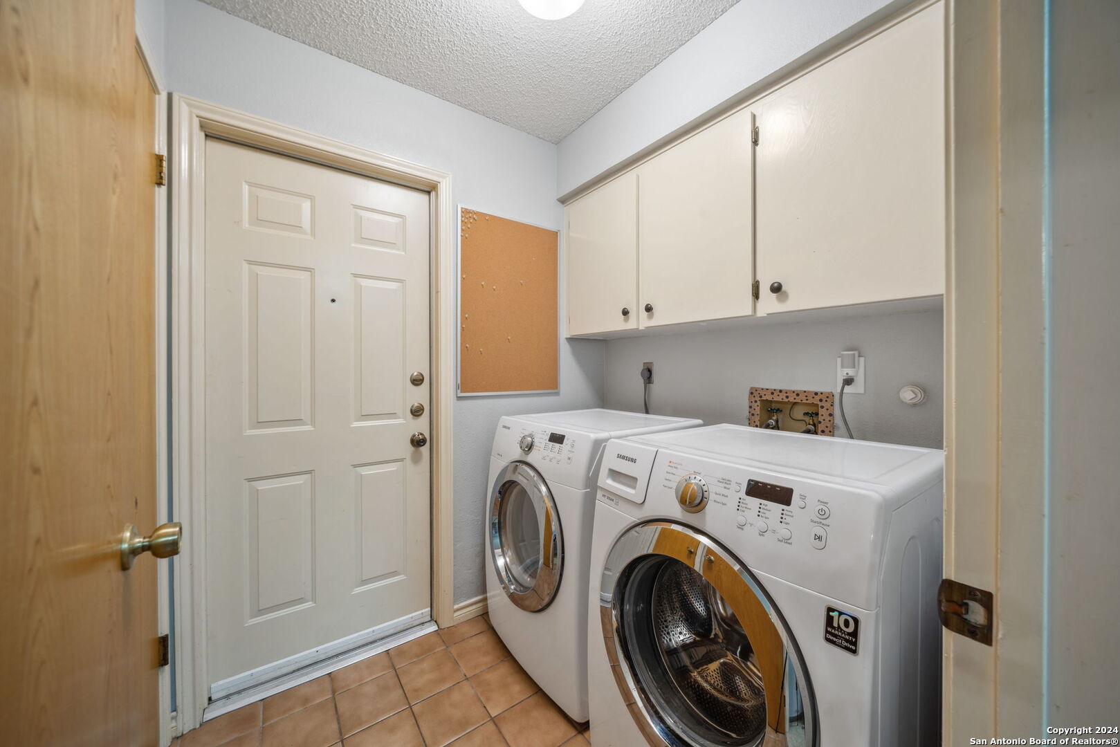 116 Bobwhite Trail Seguin, TX 78155 - Photo 16 of 23 a view of washer and dryer with kitchen in the background