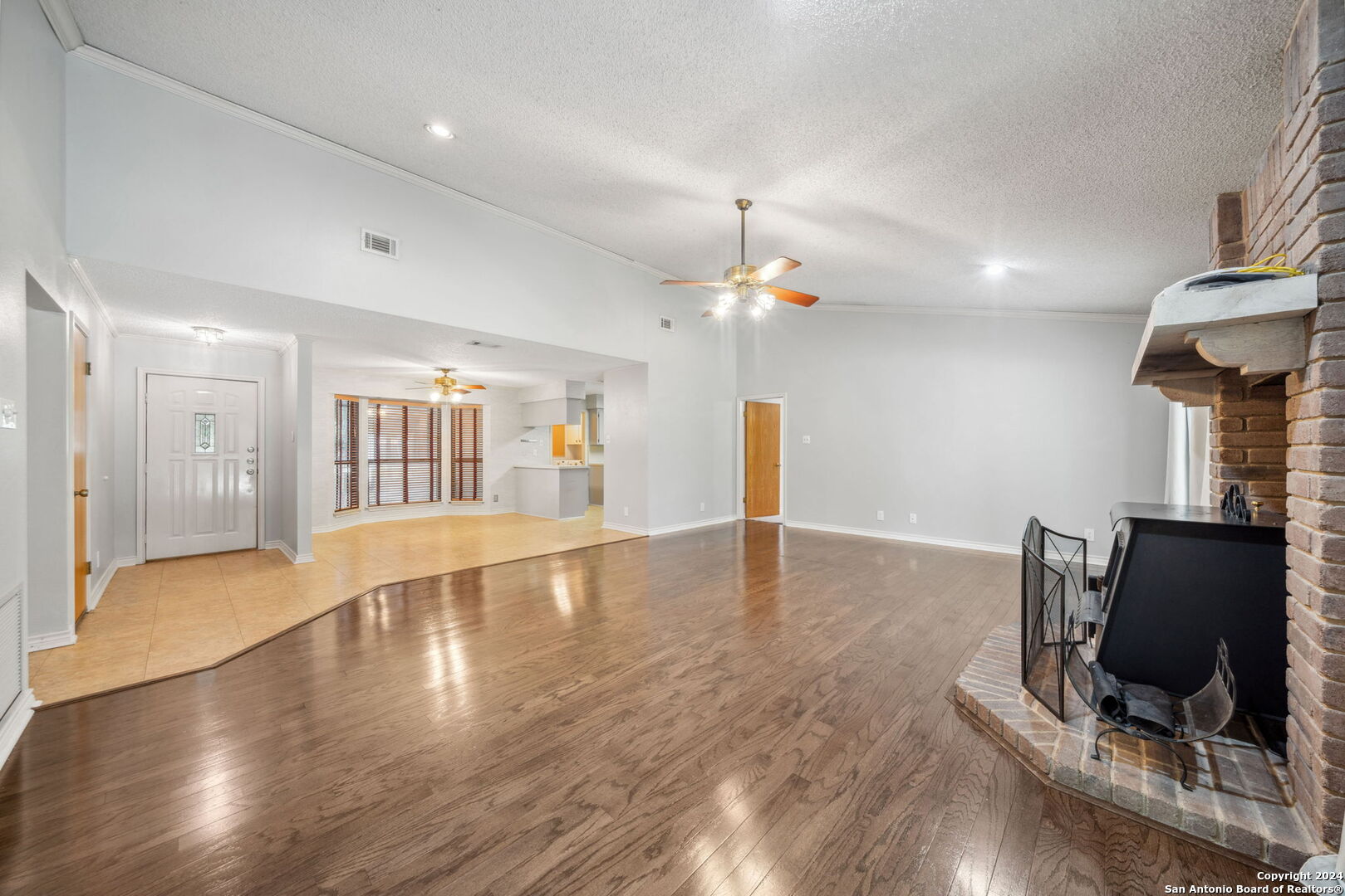 116 Bobwhite Trail Seguin, TX 78155 - Photo 4 of 23 a view of an empty room with wooden floor and a window