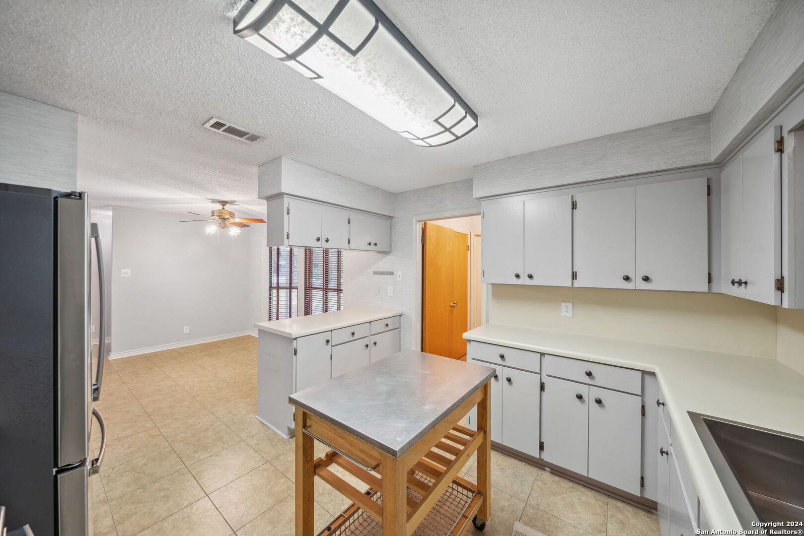 116 Bobwhite Trail Seguin, TX 78155 - Photo 9 of 23 a kitchen with a refrigerator a stove cabinets and a dining table