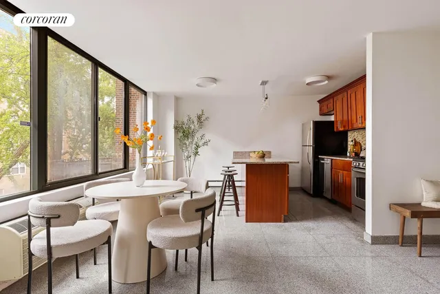 a dining room with furniture and large windows