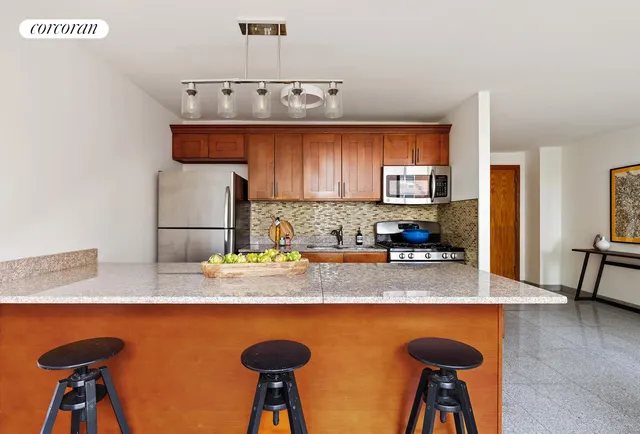 a kitchen with stainless steel appliances granite countertop a sink refrigerator stove and microwave