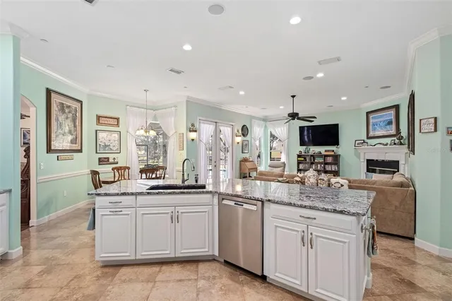 a kitchen with white cabinets and sink