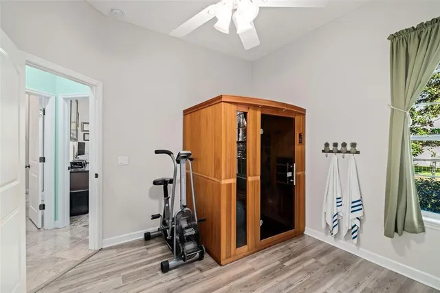 a view of a hallway with wooden floor and closet area