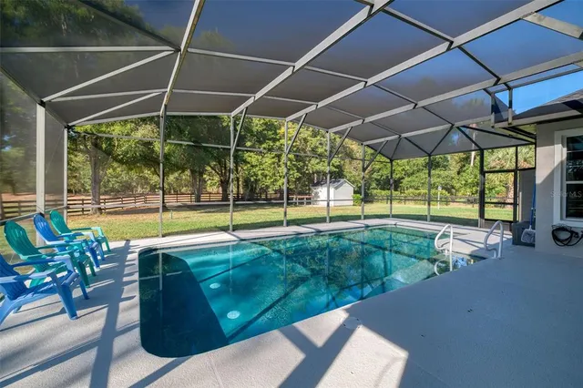 a view of a backyard with swimming pool