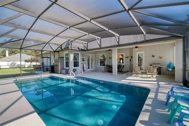 a view of a hall with a dining table and chairs