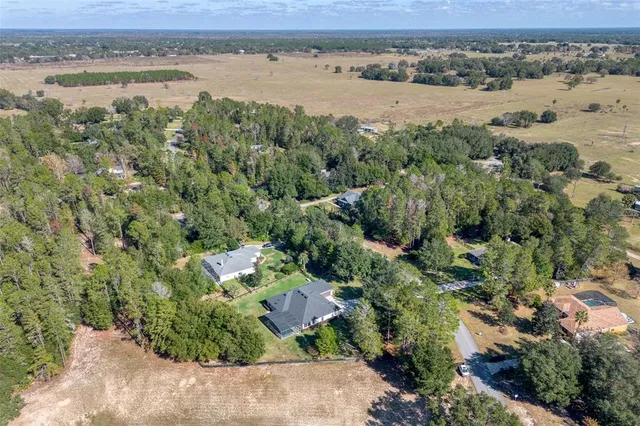 an aerial view of a houses with a lake view