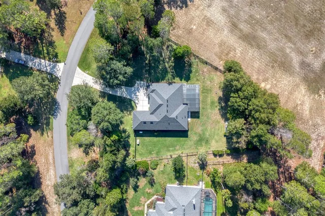 an aerial view of a house with garden space and street view