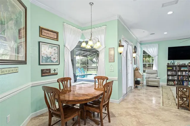 a dining room with furniture a chandelier and window