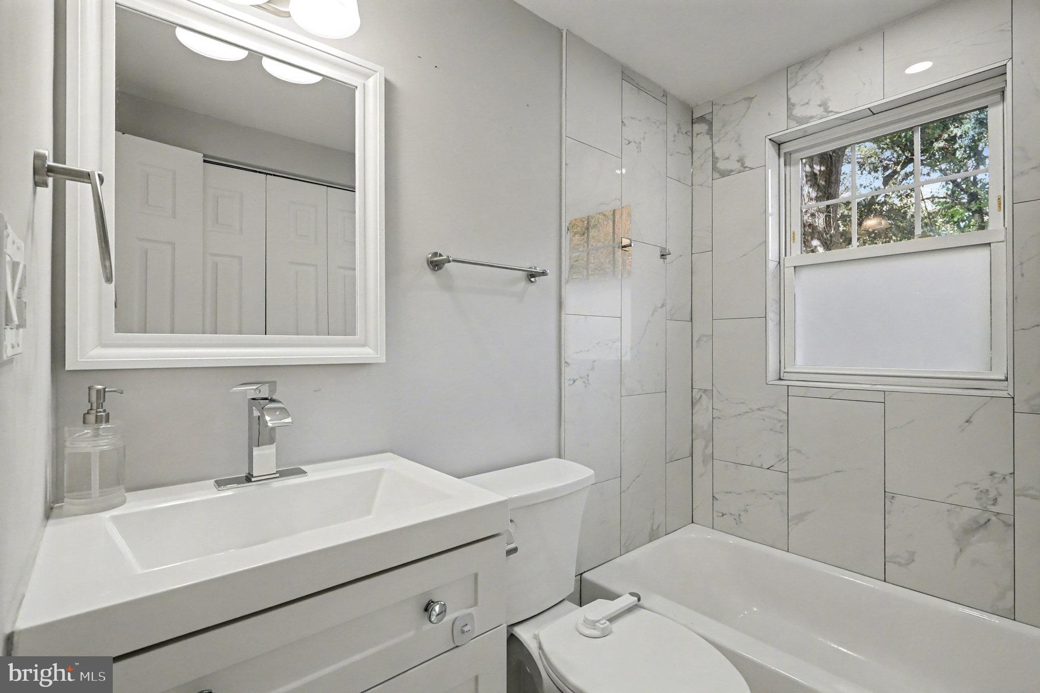 5406 Taylor Road Hyattsville, MD 20781 - Photo 12 of 26 a bathroom with a sink a toilet and shower