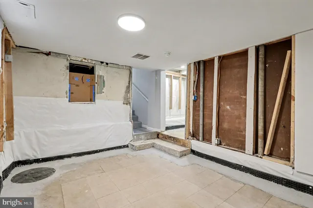 a spacious bedroom with a bed and a window