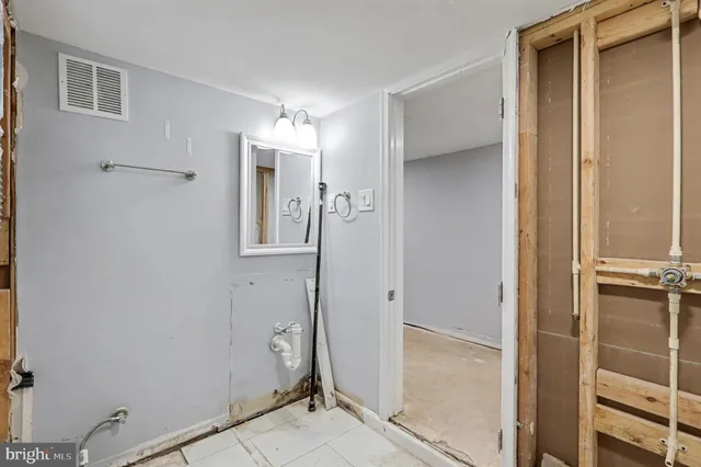 a view of a hallway with closet and wooden floor