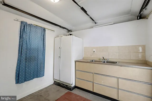 a bathroom with a granite countertop sink and shower