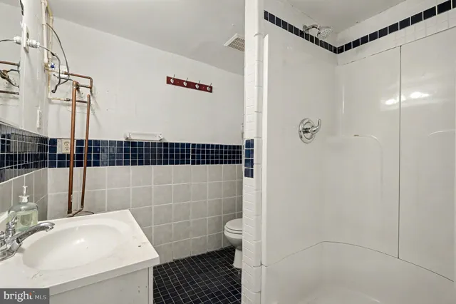 a bathroom with a sink toilet and shower