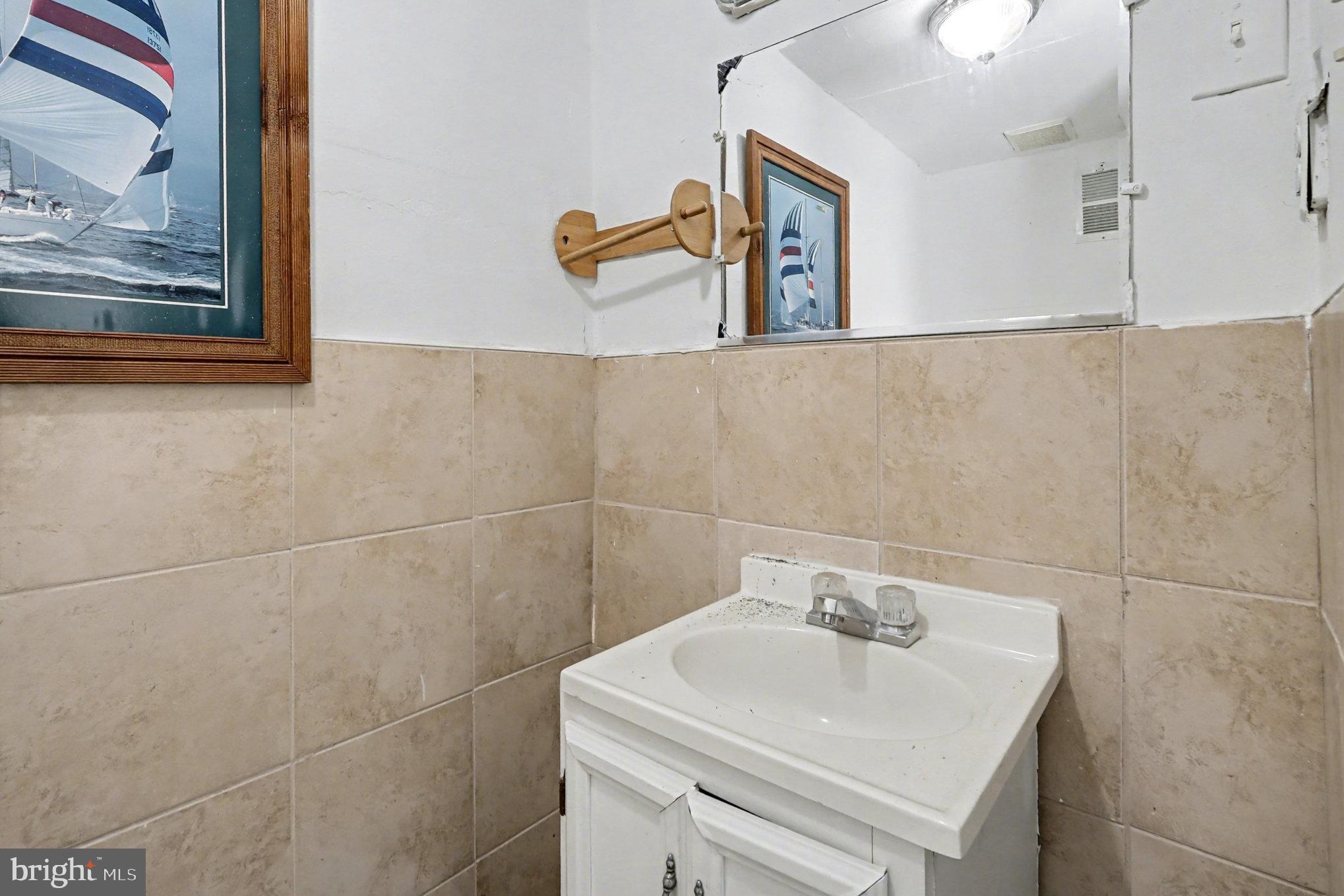 5406 Taylor Road Hyattsville, MD 20781 - Photo 25 of 26 a bathroom with a sink and mirror