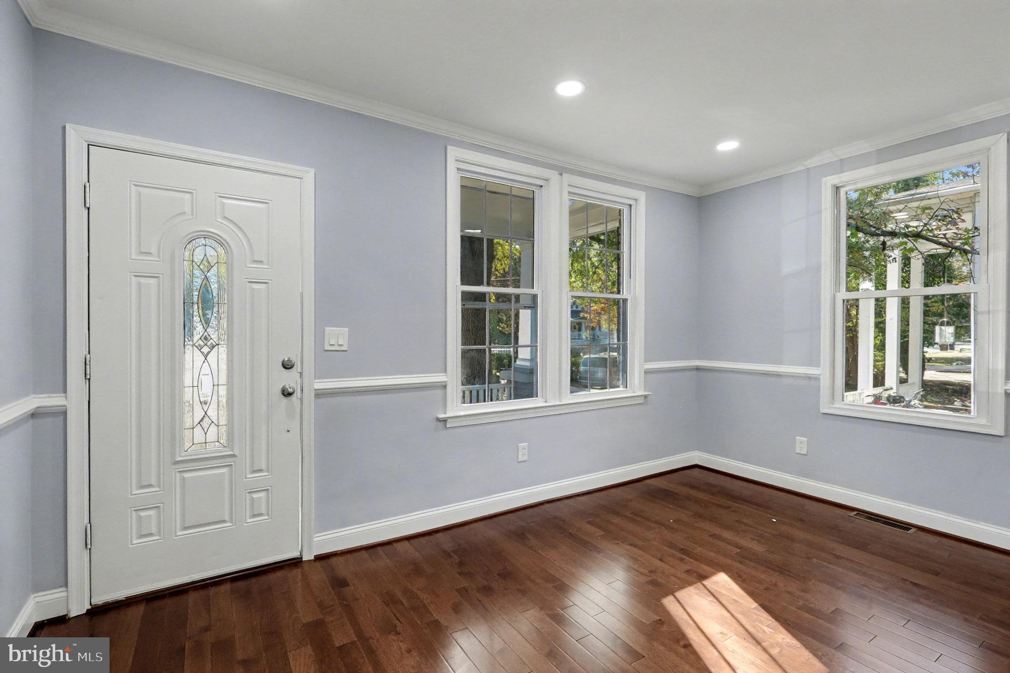5406 Taylor Road Hyattsville, MD 20781 - Photo 4 of 26 an empty room with wooden floor and windows