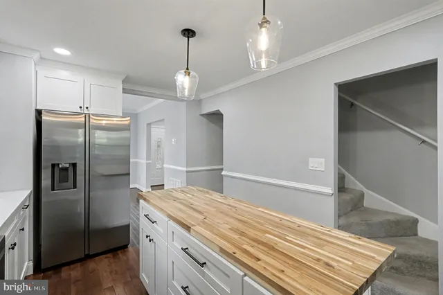 a bathroom with a refrigerator and a sink