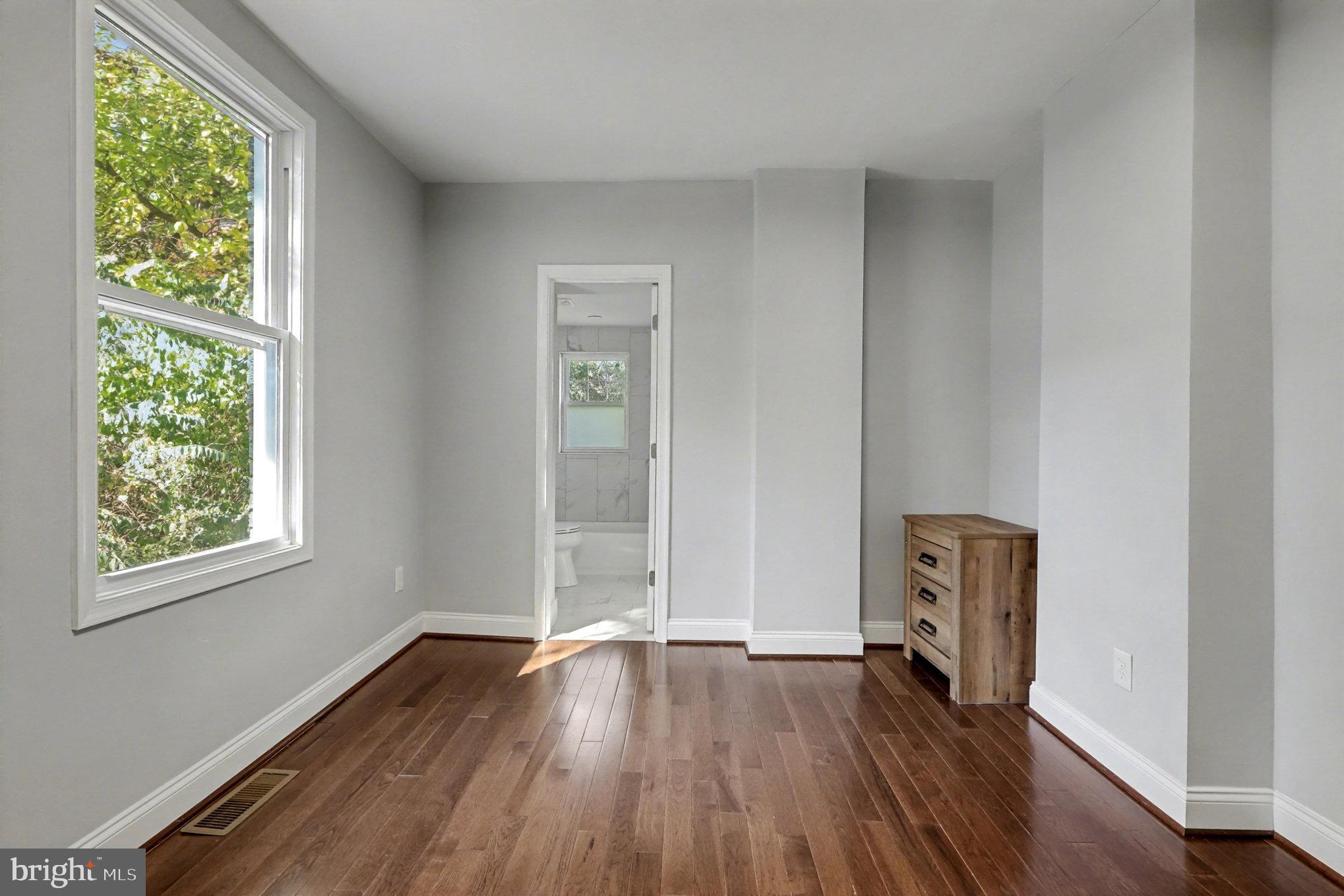 5406 Taylor Road Hyattsville, MD 20781 - Photo 10 of 26 an empty room with wooden floor and windows