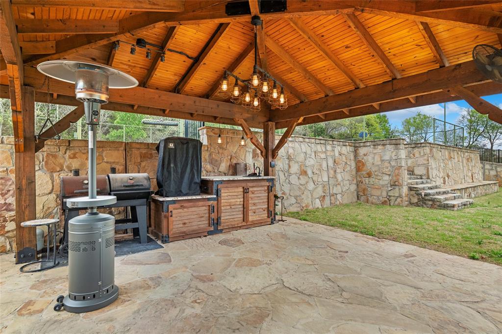 5840 Crystal Drive Midlothian, TX 76065 - Photo 28 of 36 a view of a backyard with table and chairs under an umbrella