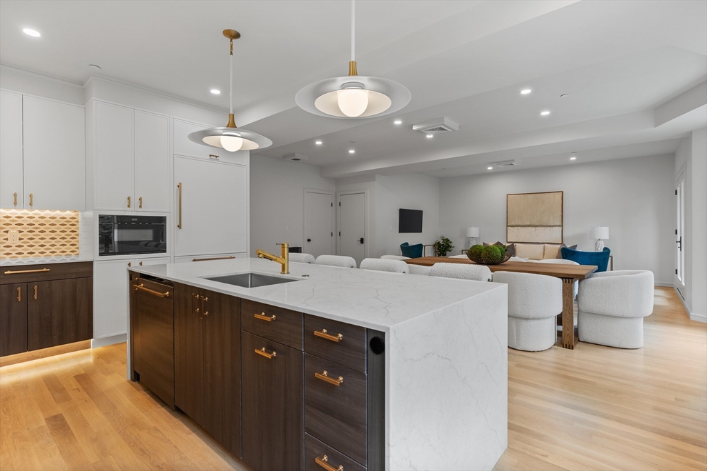 6 Claflin Road, Unit 2 Brookline, MA 02445 - Photo 12 of 39 a kitchen with a sink and a stove top oven with wooden floor
