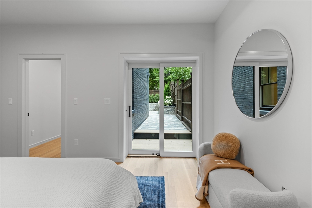 6 Claflin Road, Unit 2 Brookline, MA 02445 - Photo 18 of 39 a bedroom with a bed and glass window