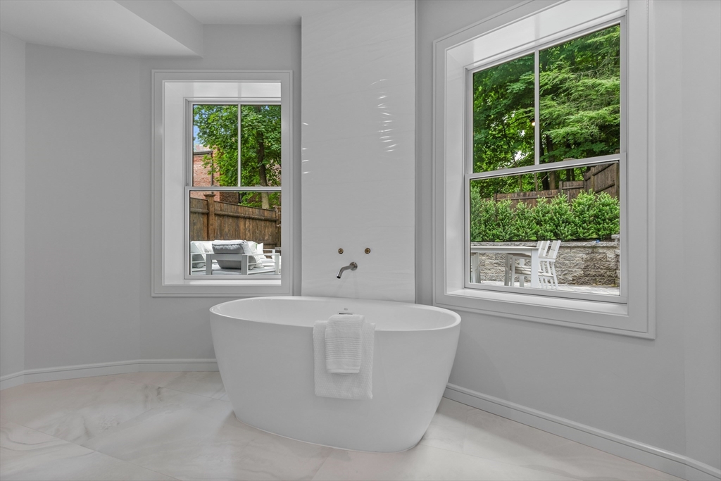 6 Claflin Road, Unit 2 Brookline, MA 02445 - Photo 21 of 39 a white bath tub sitting in a bathroom next to a window