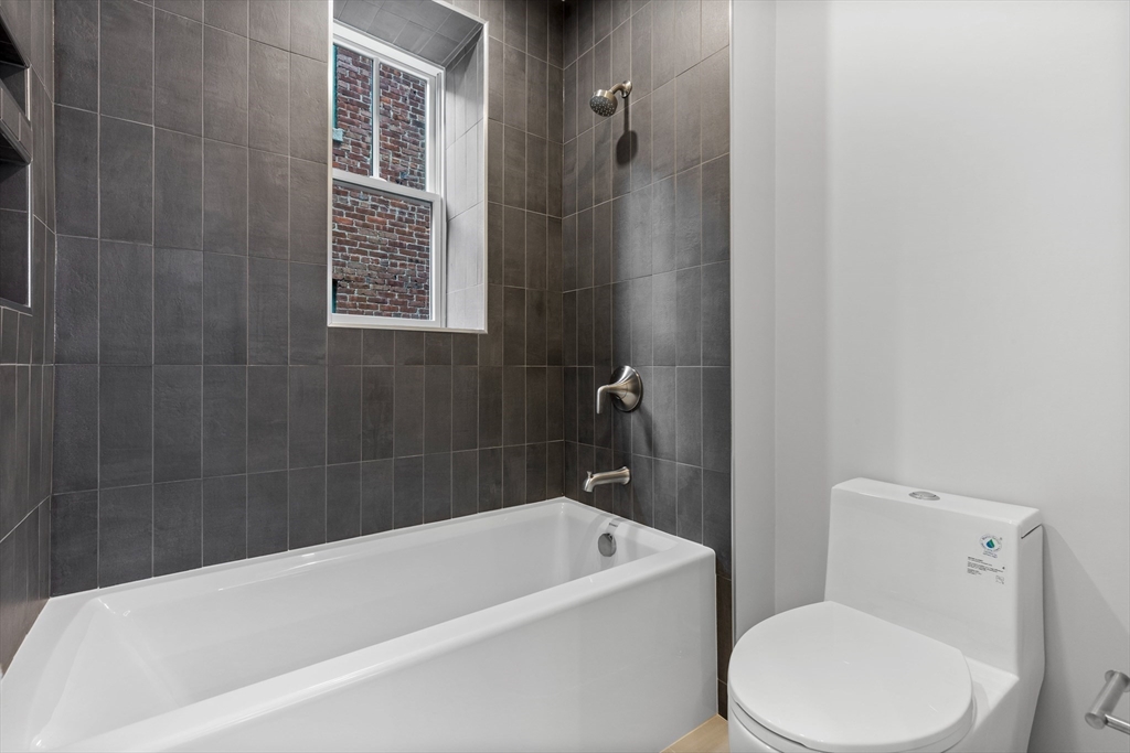 6 Claflin Road, Unit 2 Brookline, MA 02445 - Photo 24 of 39 a white bath tub sitting next to a white toilet