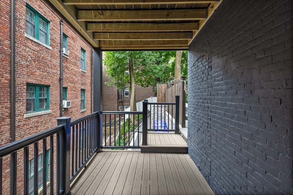 6 Claflin Road, Unit 2 Brookline, MA 02445 - Photo 29 of 39 a view of a balcony with wooden floor