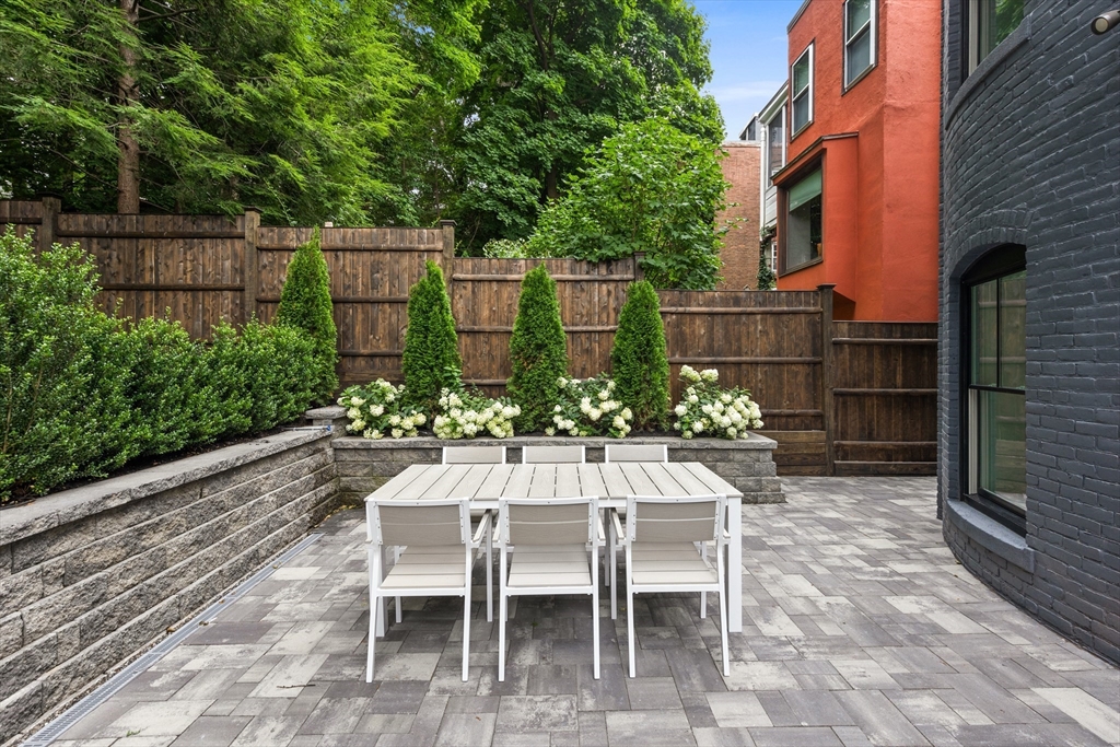 6 Claflin Road, Unit 2 Brookline, MA 02445 - Photo 32 of 39 a view of a chairs and table in backyard of the house