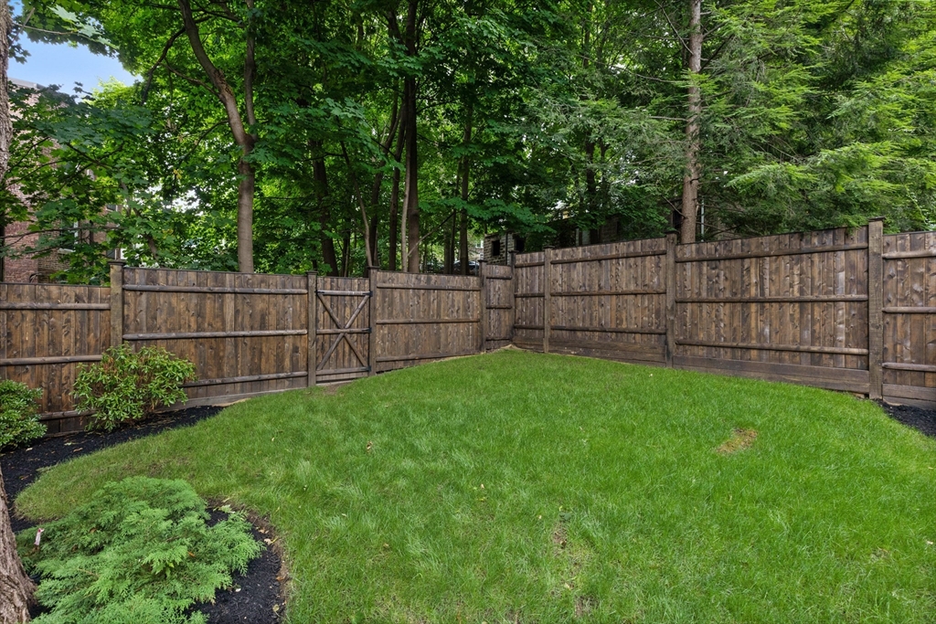 6 Claflin Road, Unit 2 Brookline, MA 02445 - Photo 35 of 39 a view of a backyard with a wooden fence