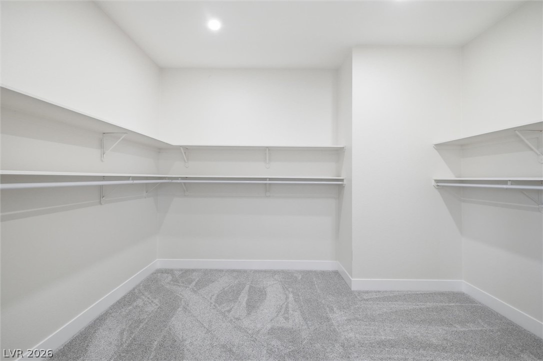5910 East Kellogg Road Pahrump, NV 89061 - Photo 36 of 58 A well-organized closet space with extensive shelving and rod systems.