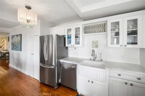 a kitchen with stainless steel appliances a refrigerator sink and cabinets