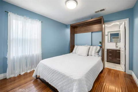 a bedroom with a bed and a mirror