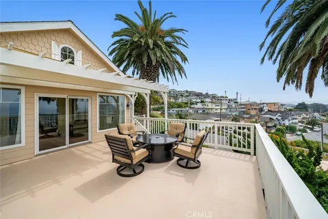a view of a balcony with wooden floor and fence