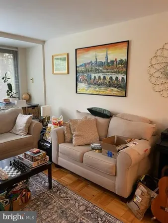 a living room with furniture and a rug